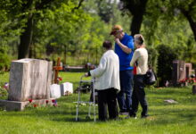 Family lays roses at Bohemian National Cemetery for Memorial Day