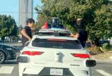 Kids sit on Waymo windows as car speeds on